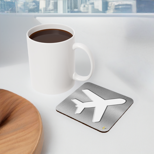 Platinum Airplane Emblem Coaster next to a coffee mug