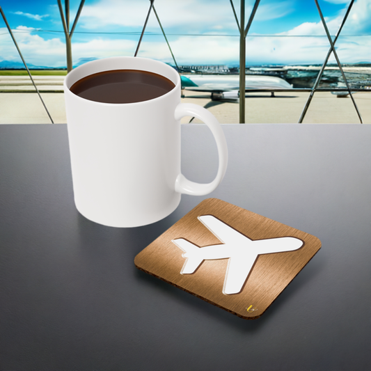 Bronze Airplane Emblem Coaster next to a coffee mug