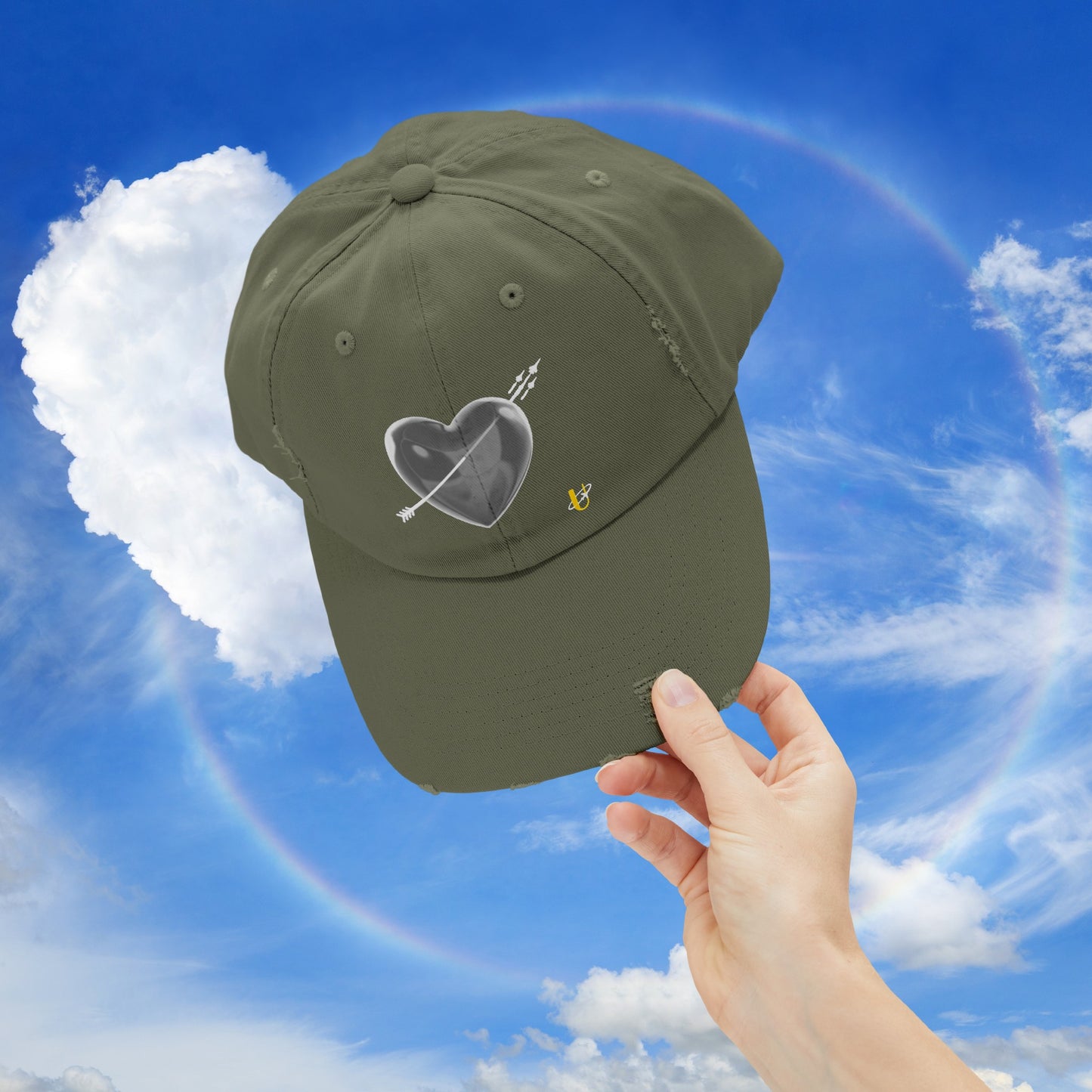 light olive "Love Jet" hat being held up in the sky